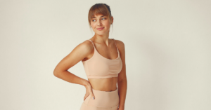 young woman in nude colored workout gear who used InMode Evolve X body sculpting