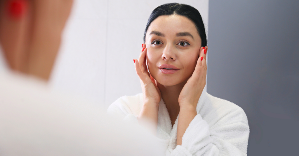 woman admiring her skin after an inmode evoke treatment